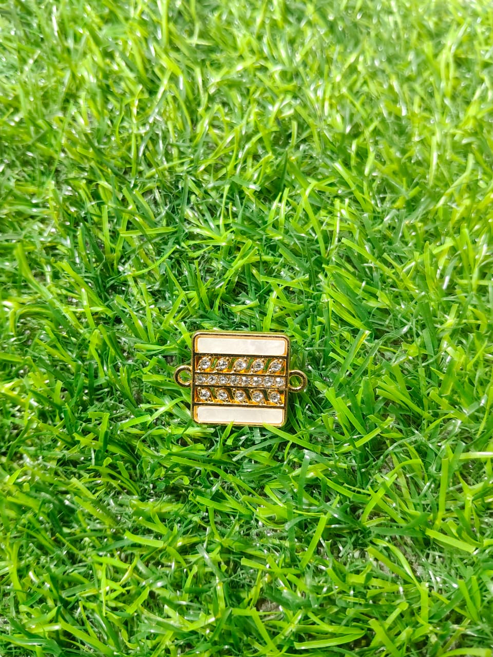 Nagneshi Rakhi Charm Rectangular Gold Frame with Dual Row American Diamonds & Mother-of-Pearl Inlay