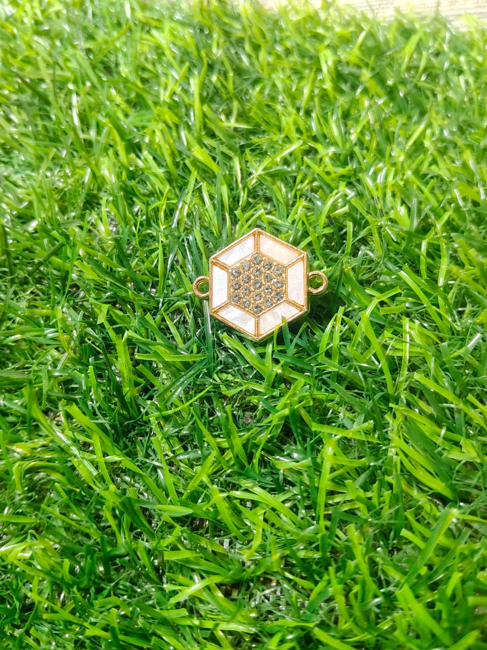 Nagneshi Elegant Rakhi Charm Hexagonal Gold Frame with American Diamond & Mother-of-Pearl Inlay