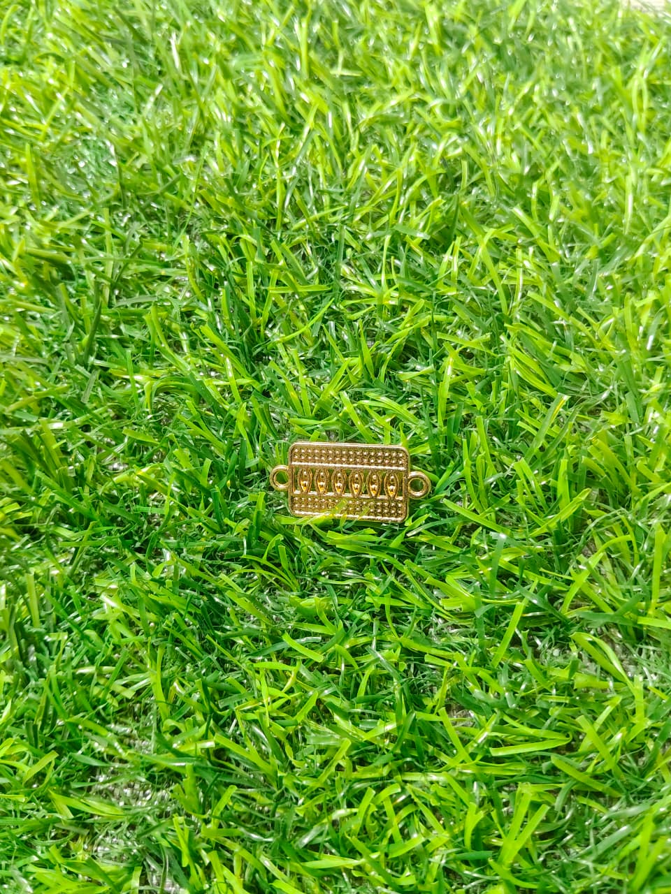 Nagneshi Rakhi Charm Rectangular Gold Frame with American Diamond & Mother-of-Pearl Inlay