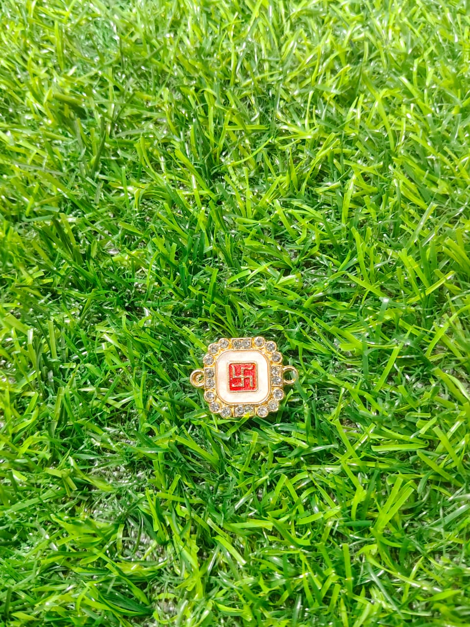Nagneshi Rakhi Charm Octagonal Gold Frame with Auspicious Swastik Motif & American Diamond Border