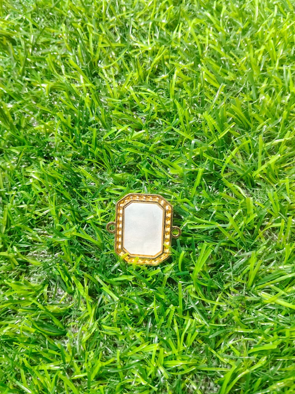 Nagneshi Rakhi Charm Rectangular Gold Frame with Nagneshi Rakhi Charm Octagonal Gold Frame with Intricate Motif & American Diamond BorderDiamond & Mother-of-Pearl Inlay (Copy)