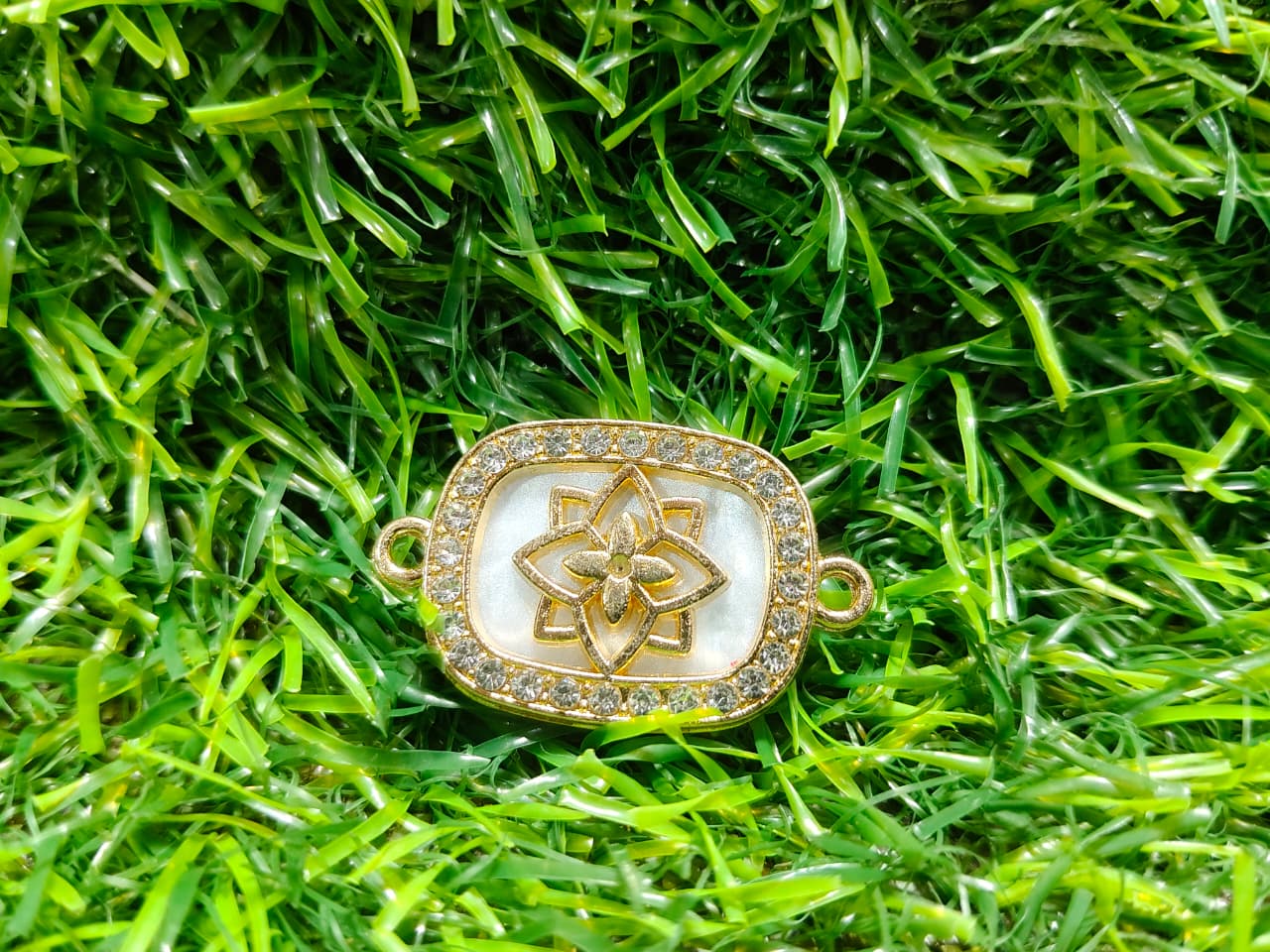 Nagneshi Rakhi Charm Rectangular Gold Frame with Floral Motif, Mother-of-Pearl Base & American Diamond Border